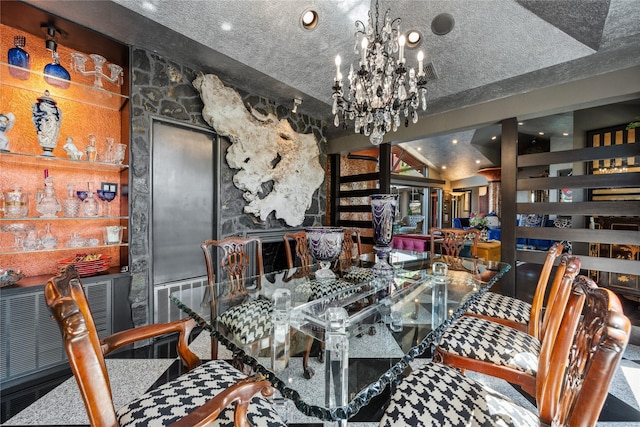 dining area featuring visible vents, built in features, vaulted ceiling, an inviting chandelier, and a textured ceiling