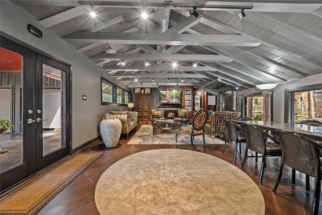 interior space with french doors, track lighting, wooden ceiling, and vaulted ceiling with beams