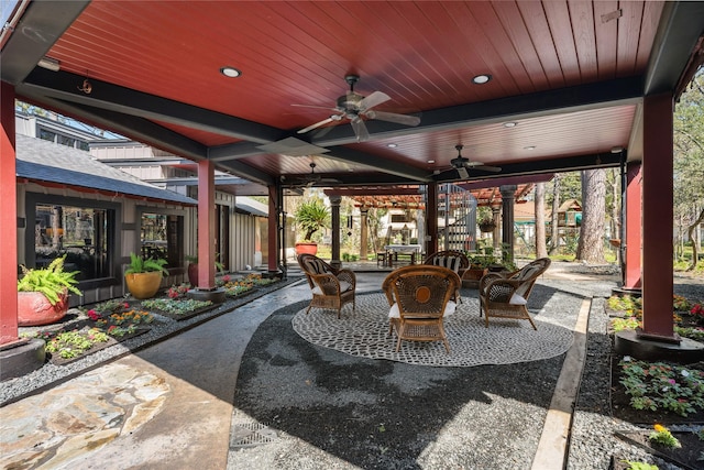 view of patio with outdoor dining area and a ceiling fan