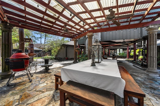 view of patio with area for grilling, outdoor dining space, and a ceiling fan