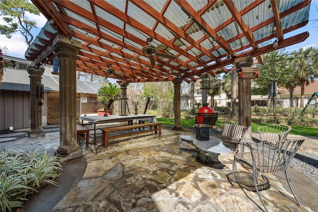 view of patio with outdoor dining space, area for grilling, a ceiling fan, and fence