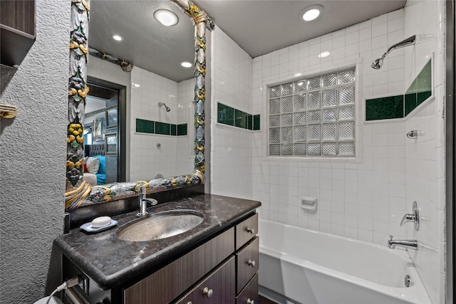 bathroom featuring a textured ceiling, recessed lighting, shower / tub combo, vanity, and a textured wall