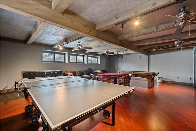 recreation room with billiards, wood finished floors, ceiling fan, track lighting, and beamed ceiling