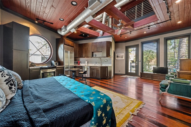 bedroom featuring a sink, multiple windows, wood ceiling, and wood finished floors