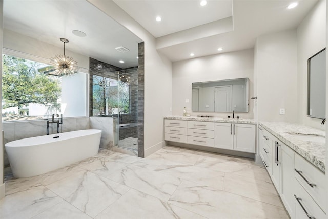 bathroom featuring a soaking tub, two vanities, a sink, a shower stall, and marble finish floor