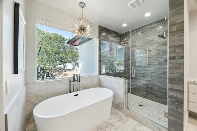 full bath with a soaking tub, plenty of natural light, visible vents, and a shower stall