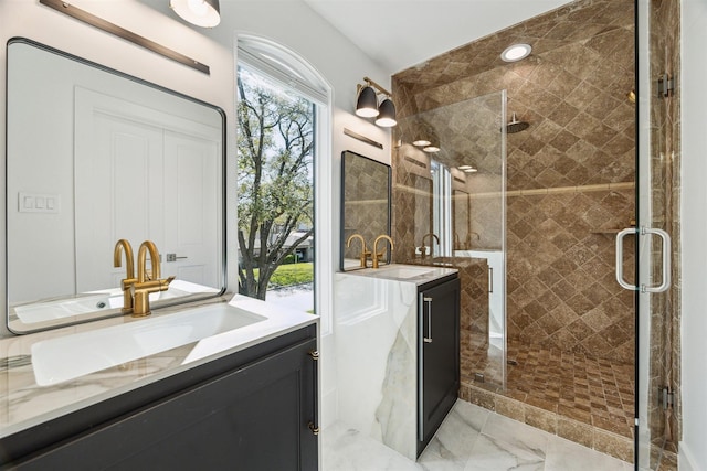 bathroom with a sink, two vanities, and a stall shower