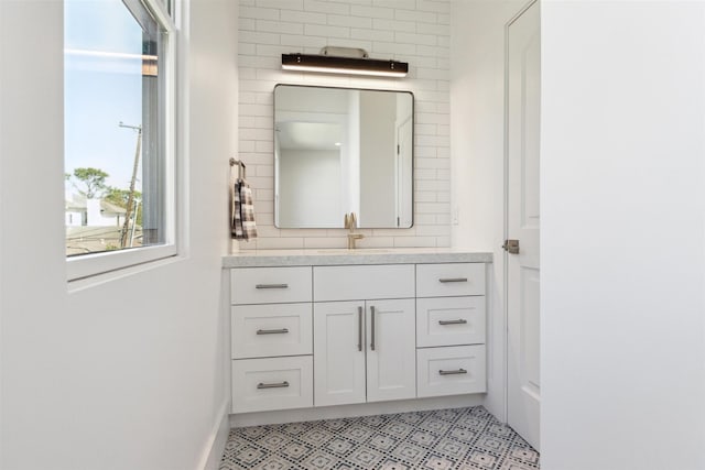 bathroom featuring tasteful backsplash and vanity