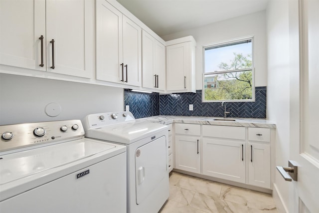 laundry room with washer and dryer, cabinet space, marble finish floor, and a sink