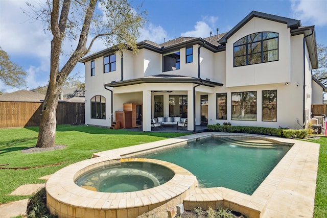 rear view of property with a patio, fence, stucco siding, a lawn, and an outdoor hangout area