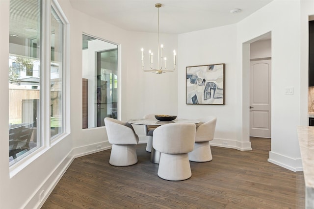 dining space featuring a notable chandelier, dark wood-type flooring, and baseboards