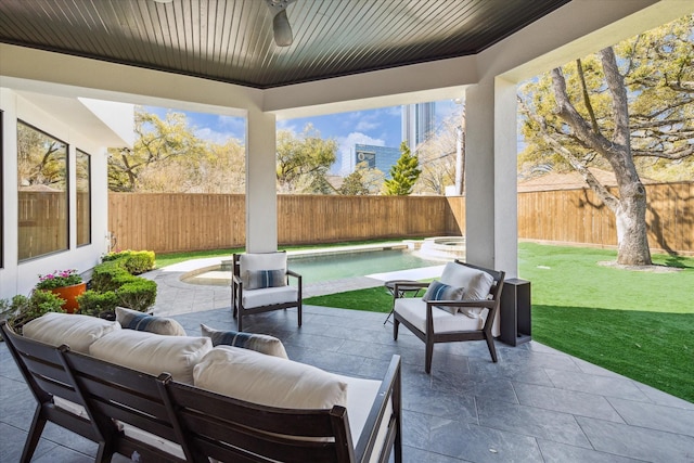 view of patio / terrace with a fenced backyard and a pool with connected hot tub