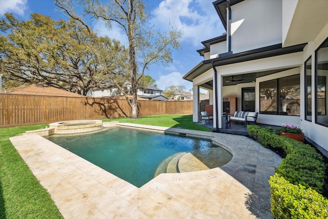 view of swimming pool featuring a patio area, a yard, a pool with connected hot tub, and a fenced backyard