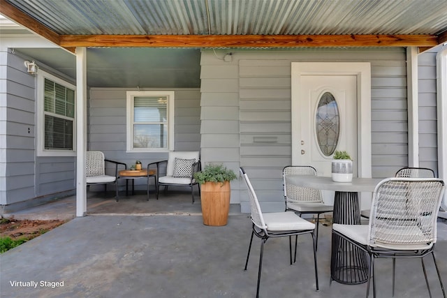 view of patio / terrace with outdoor dining space and a porch