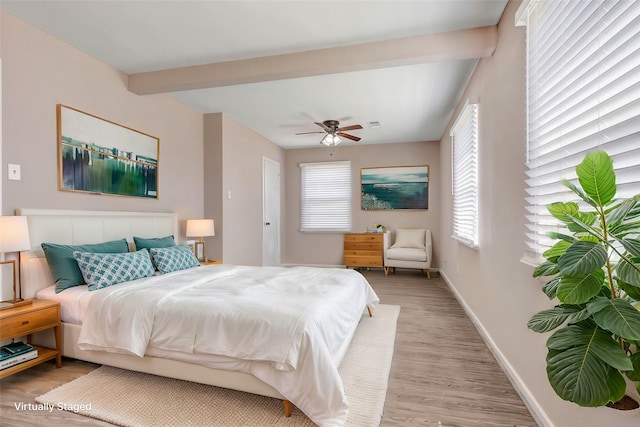 bedroom with beamed ceiling, baseboards, ceiling fan, and light wood finished floors