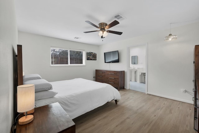 bedroom with baseboards, visible vents, light wood finished floors, and ceiling fan