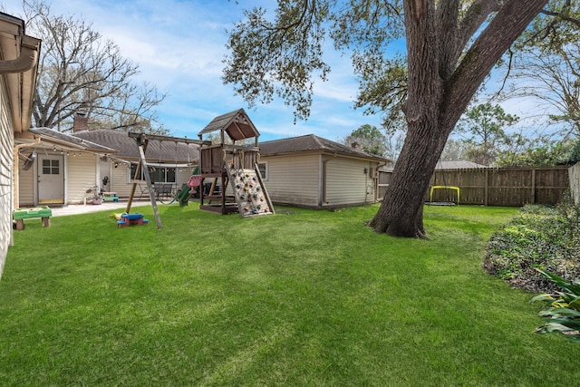 view of yard with a playground, a patio, and fence