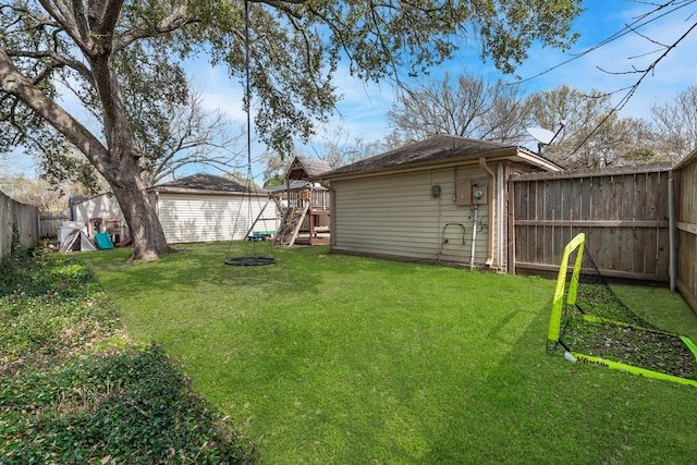 view of yard featuring a fenced backyard and a playground