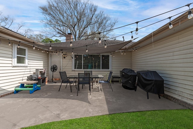 view of patio with grilling area and outdoor dining space