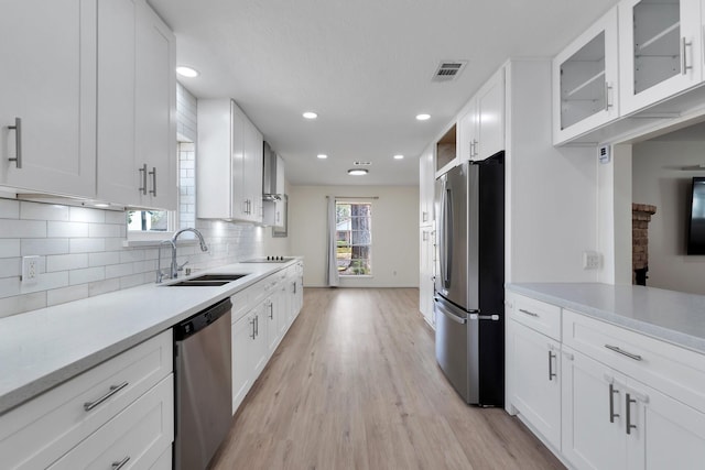 kitchen with visible vents, a sink, light countertops, white cabinets, and appliances with stainless steel finishes