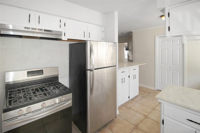 kitchen with under cabinet range hood, white cabinetry, appliances with stainless steel finishes, light countertops, and light tile patterned floors