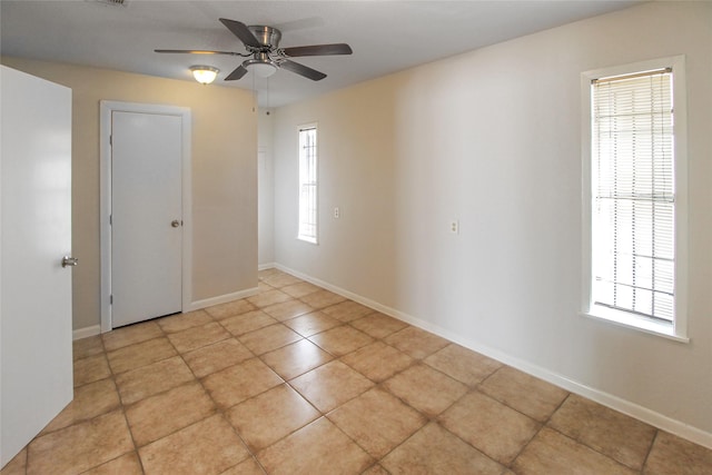 unfurnished room with visible vents, baseboards, and a ceiling fan