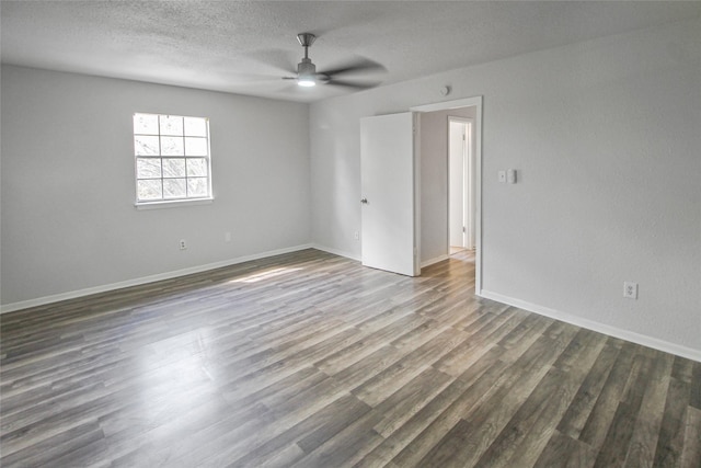 spare room featuring wood finished floors, a ceiling fan, baseboards, and a textured ceiling