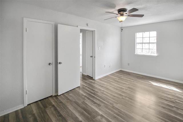 unfurnished bedroom featuring a ceiling fan, wood finished floors, and baseboards