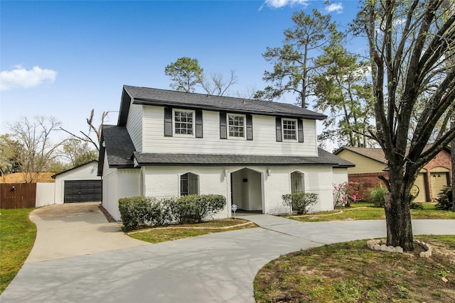 view of front of home with a garage, curved driveway, roof with shingles, and fence