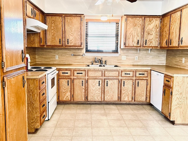 kitchen featuring white appliances, a ceiling fan, a sink, light countertops, and under cabinet range hood