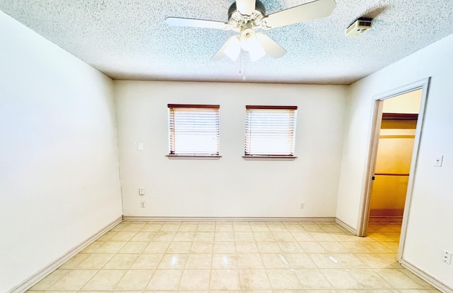 unfurnished room featuring a ceiling fan, baseboards, and a textured ceiling