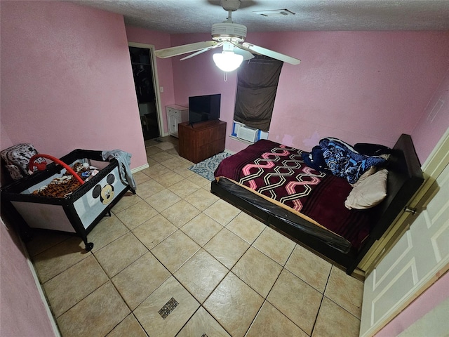 tiled bedroom featuring visible vents, a textured ceiling, and ceiling fan