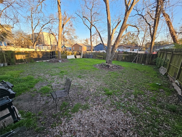 view of yard with a fenced backyard and a residential view