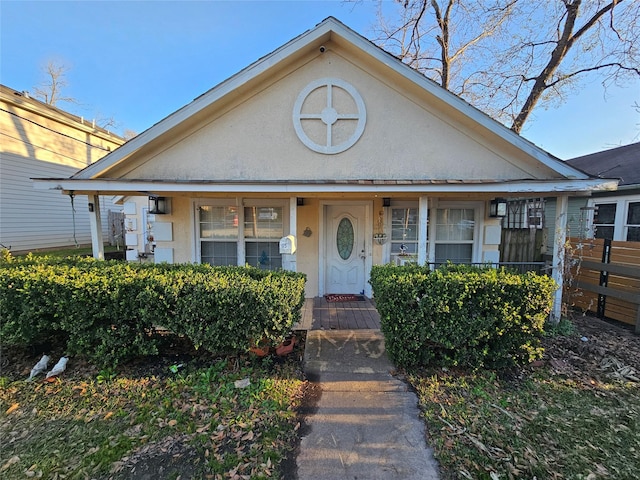 view of front of home featuring covered porch and stucco siding