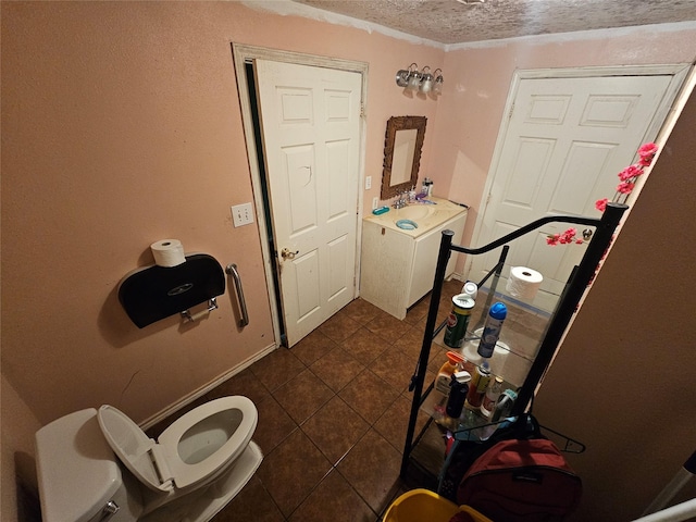 bathroom with tile patterned floors, a textured ceiling, and toilet