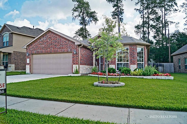 view of front of home featuring a garage, driveway, brick siding, and a front yard