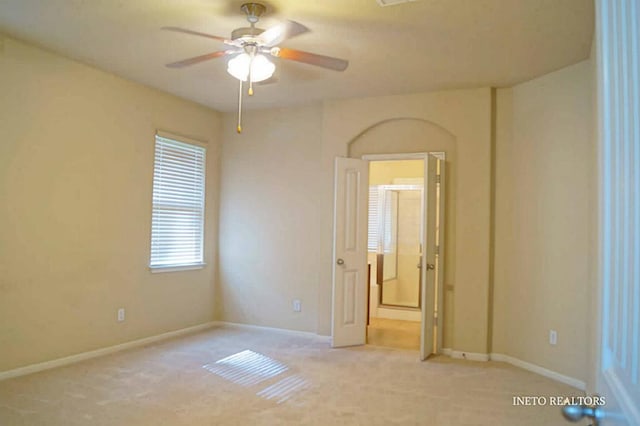 carpeted empty room with baseboards and ceiling fan