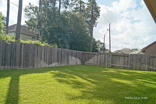 view of yard with a fenced backyard