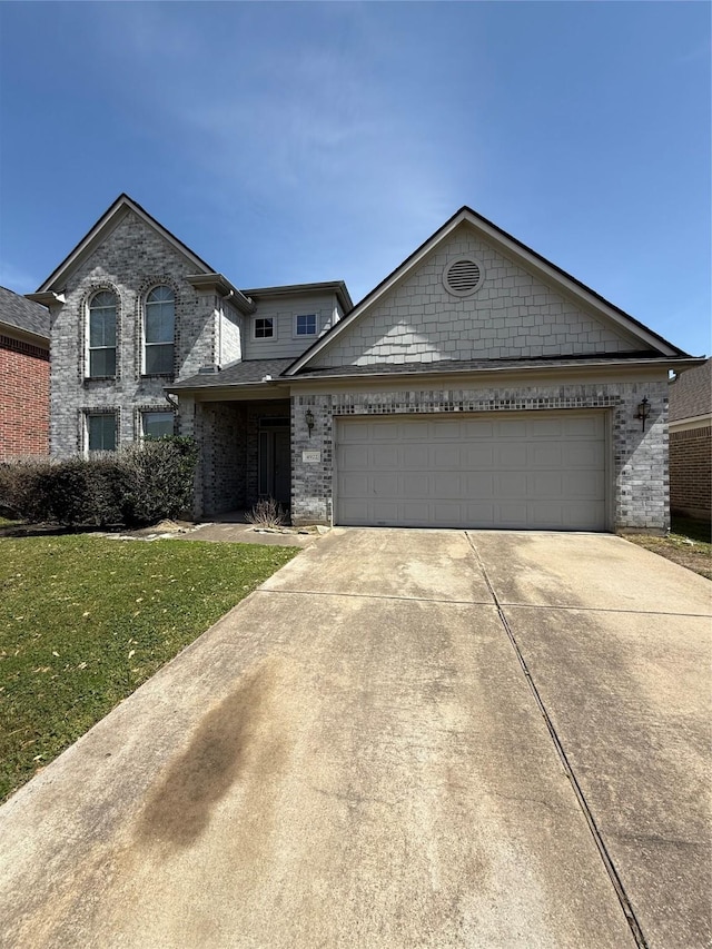 view of front of home with brick siding, a front yard, concrete driveway, and an attached garage