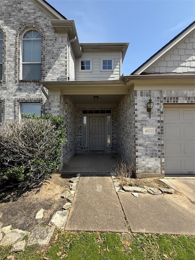 doorway to property featuring brick siding