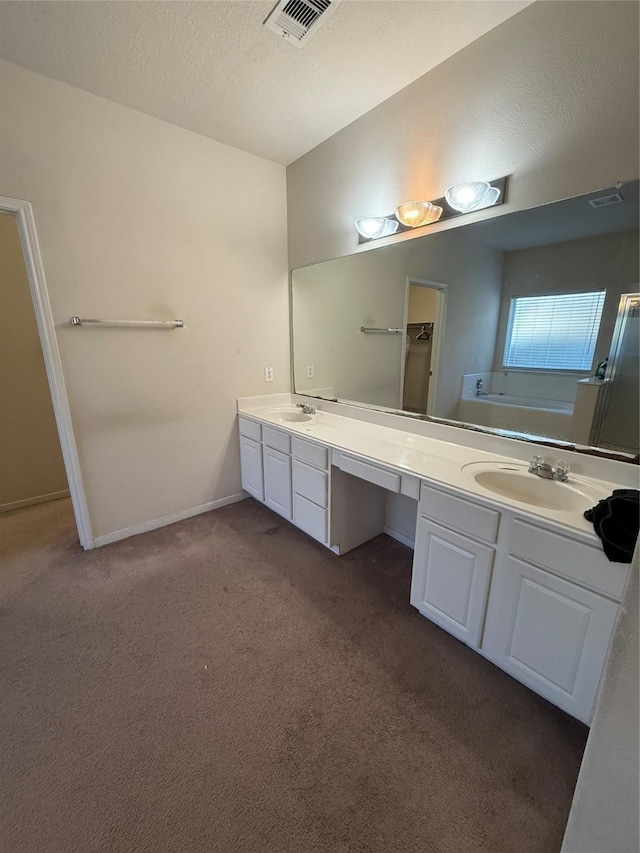 bathroom with double vanity, carpet flooring, visible vents, and a sink