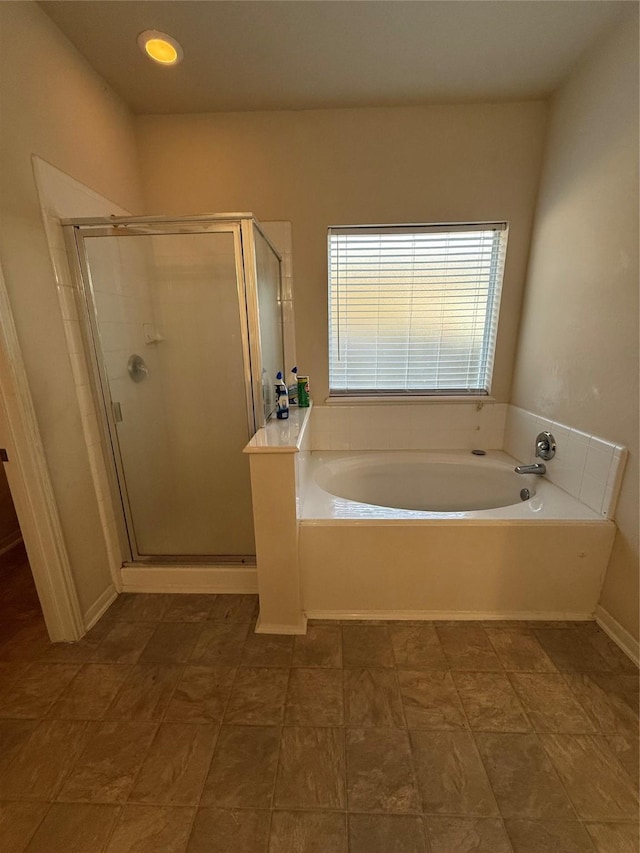 bathroom with a garden tub and a stall shower