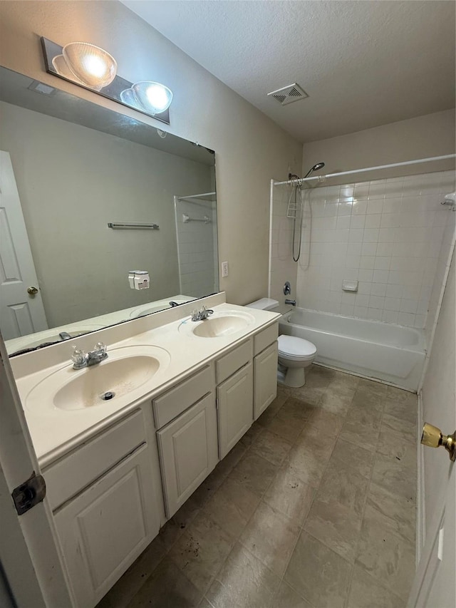 bathroom featuring double vanity, toilet, shower / bathtub combination, and a sink