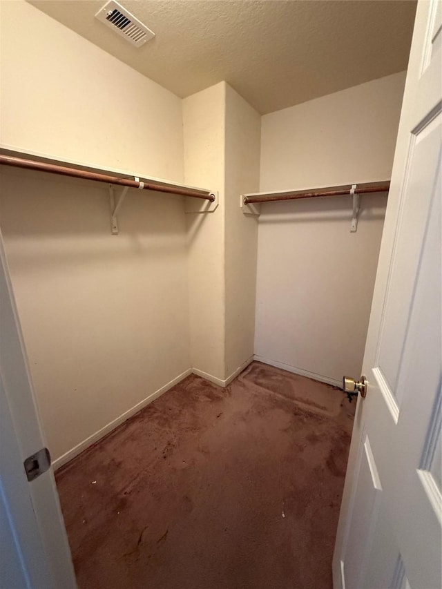 walk in closet with visible vents and carpet flooring