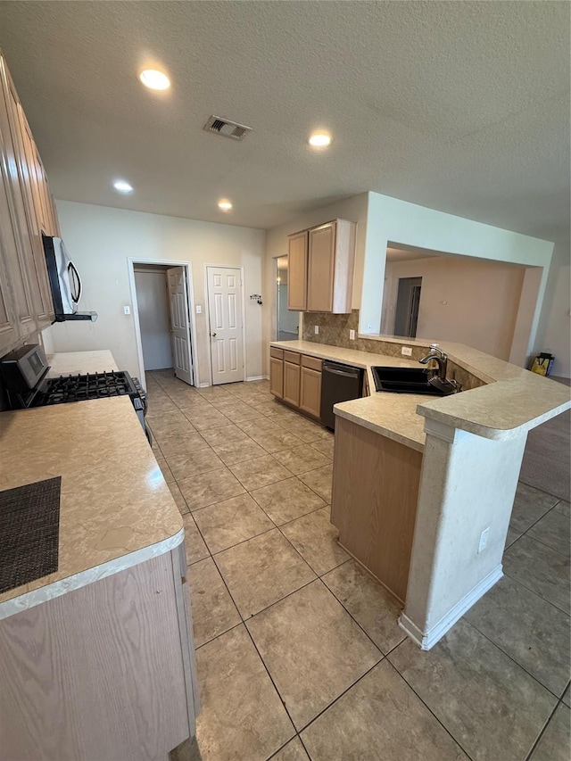 kitchen with light countertops, visible vents, appliances with stainless steel finishes, and a sink