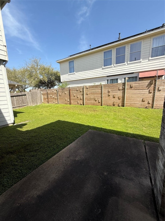 view of yard featuring a patio and fence