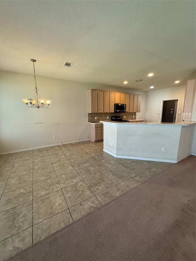 kitchen featuring visible vents, recessed lighting, stainless steel appliances, an inviting chandelier, and a textured ceiling