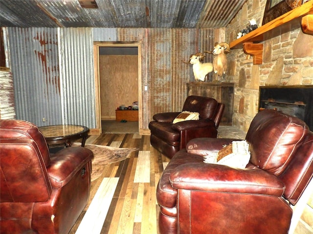 12830 Fm 1280, Lovelady, TX 75851 - sitting room featuring a stone fireplace and hardwood / wood-style flooring