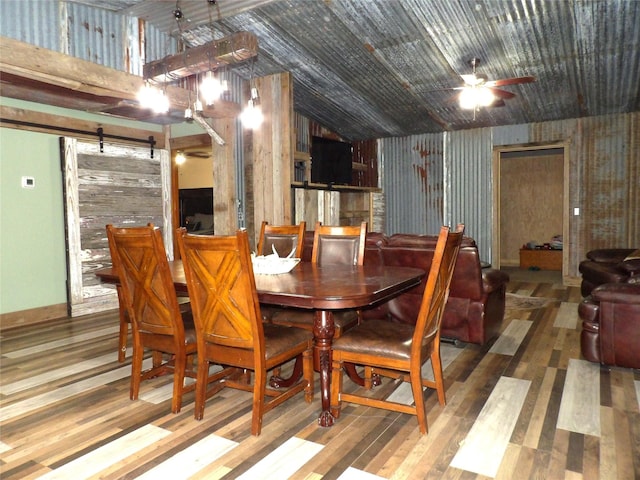 12830 Fm 1280, Lovelady, TX 75851 - dining space featuring a barn door, lofted ceiling, ceiling fan, and wood finished floors