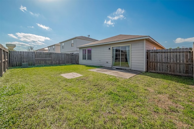 rear view of property with a patio area, a lawn, and a fenced backyard